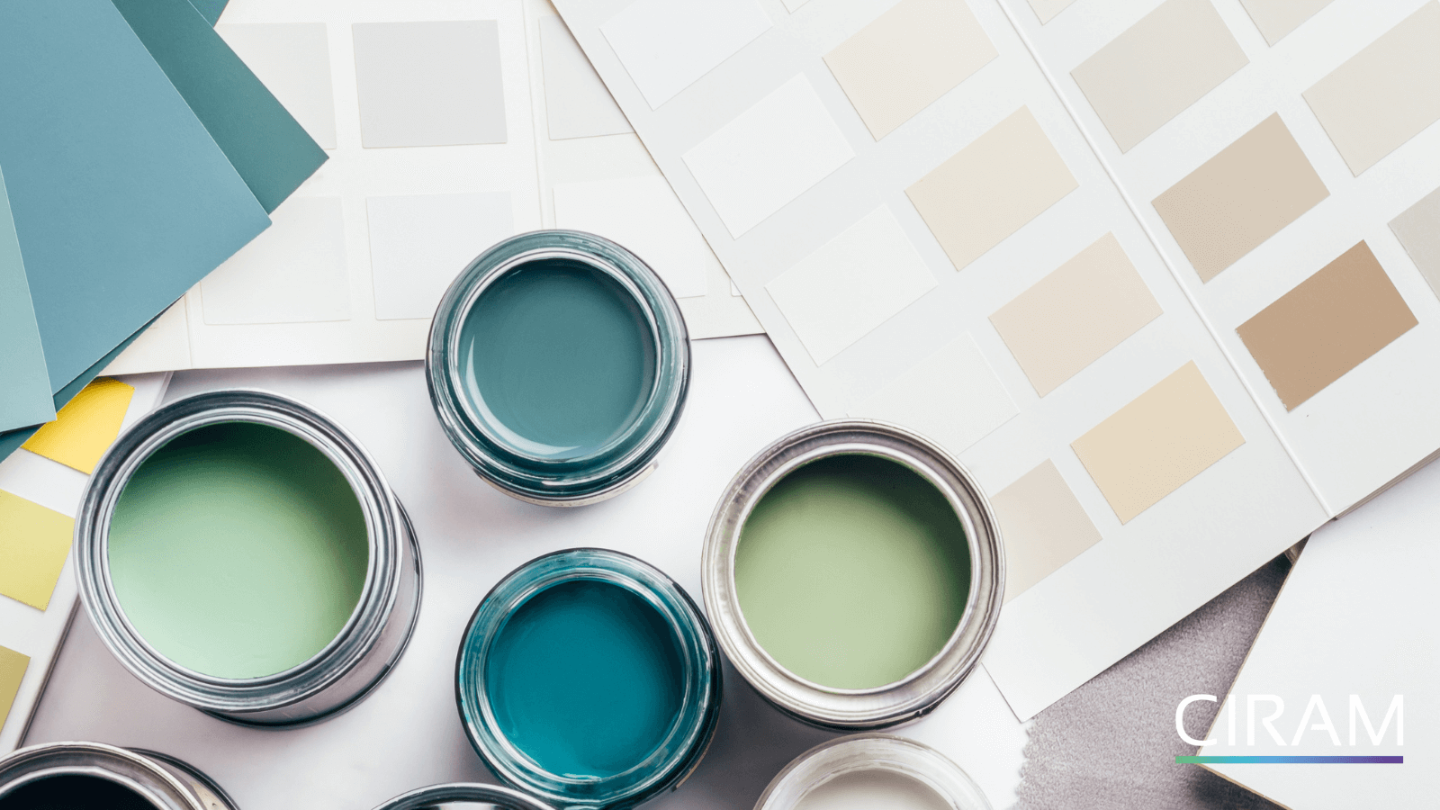 Paint pots arranged next to a color swatch chart