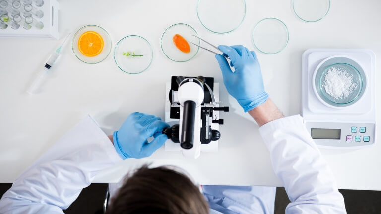 Scientist observing natural product samples