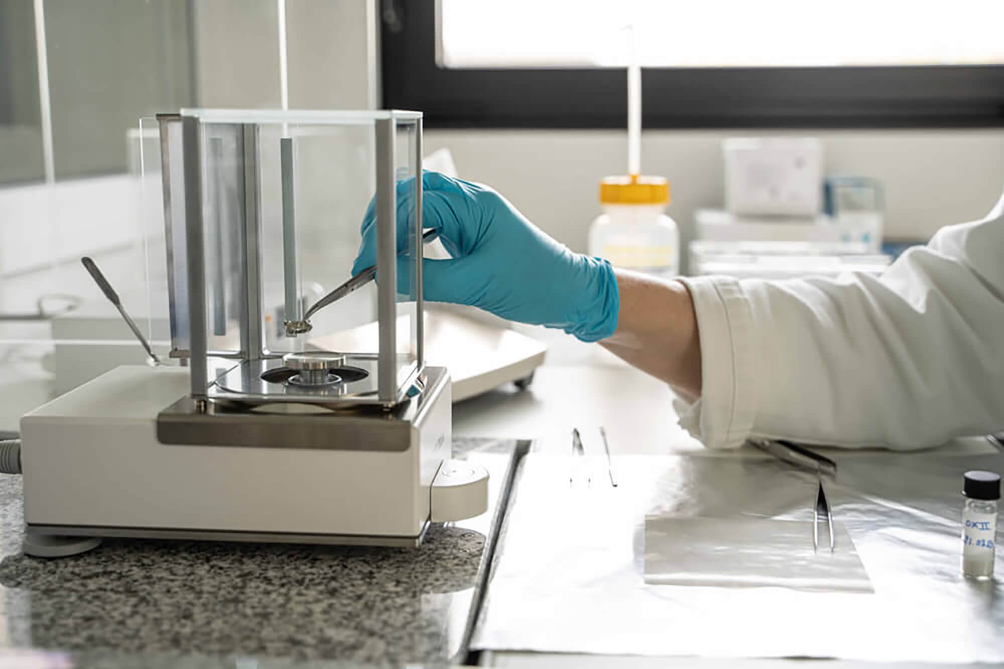 Laboratory technician preparing a sample for precise weighing