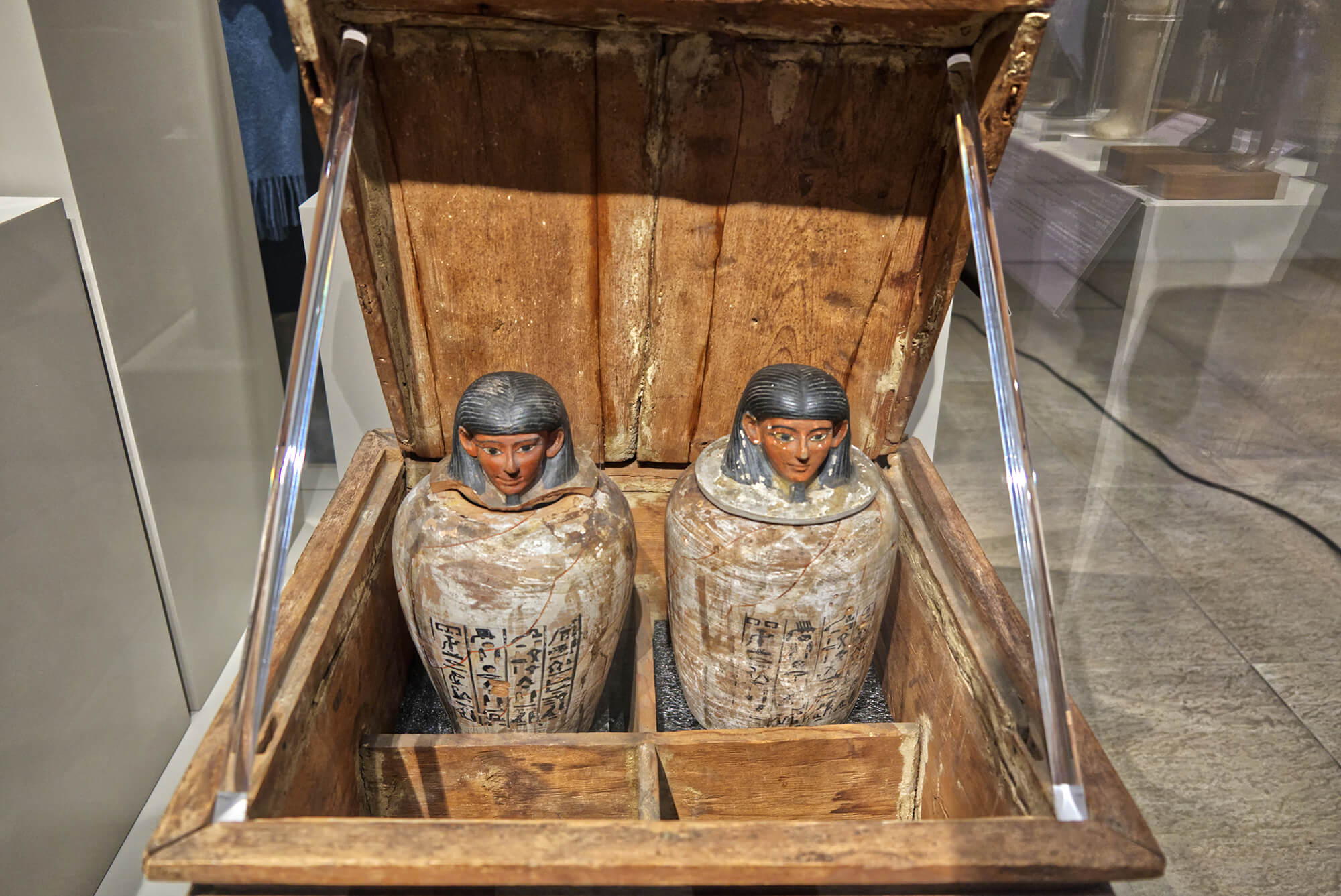 Egyptian cinerary urns in museum display case