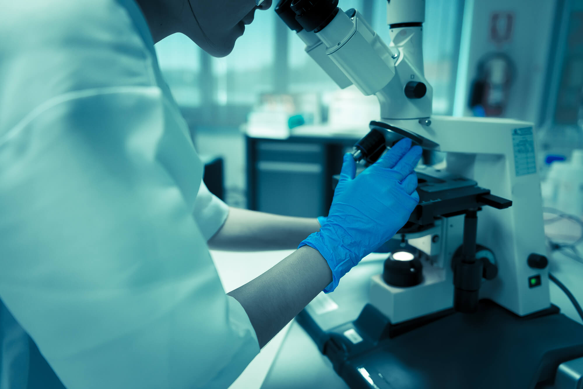 Scientist looking through a microscope
