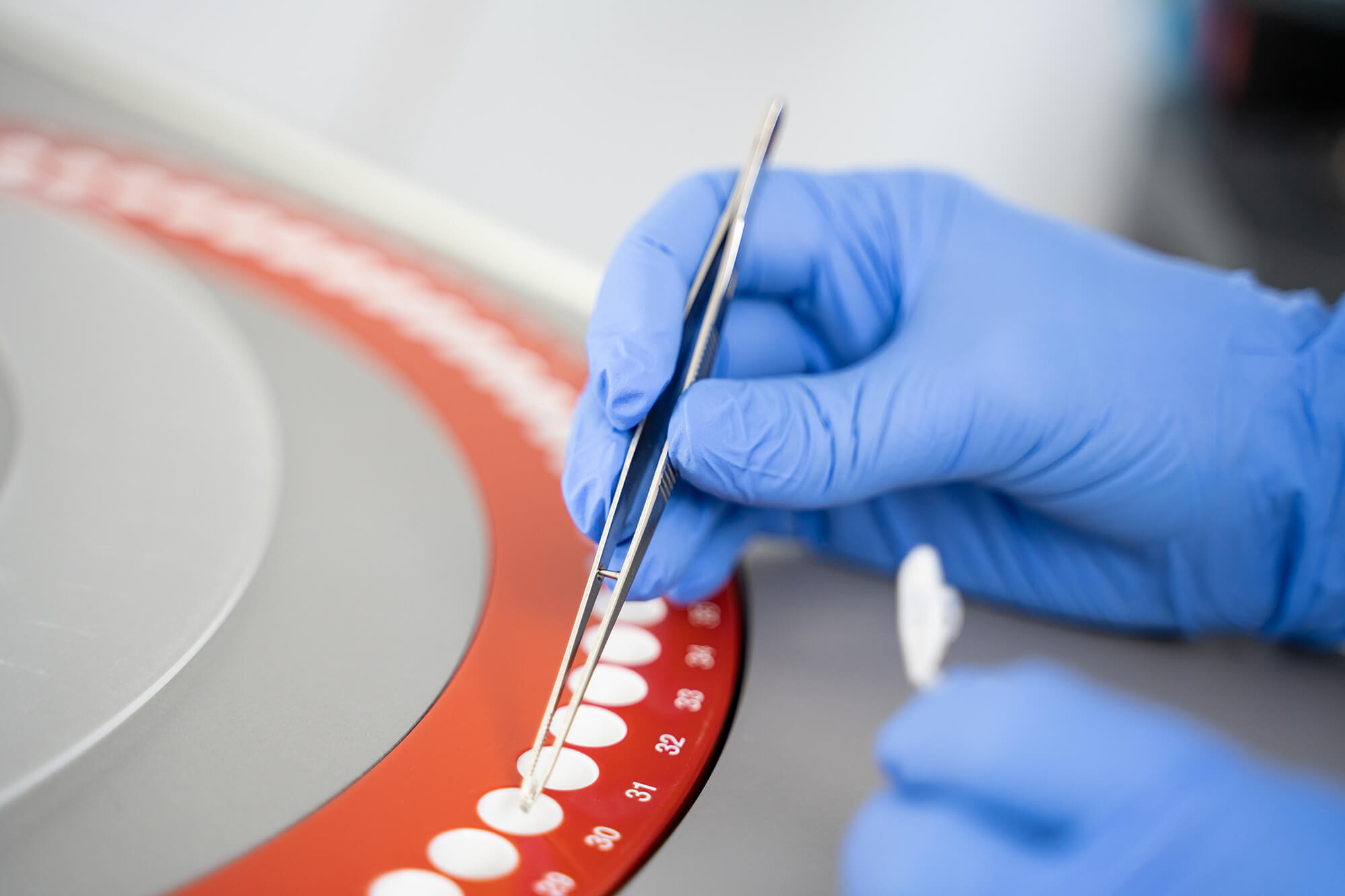 Scientist loading samples into a centrifuge