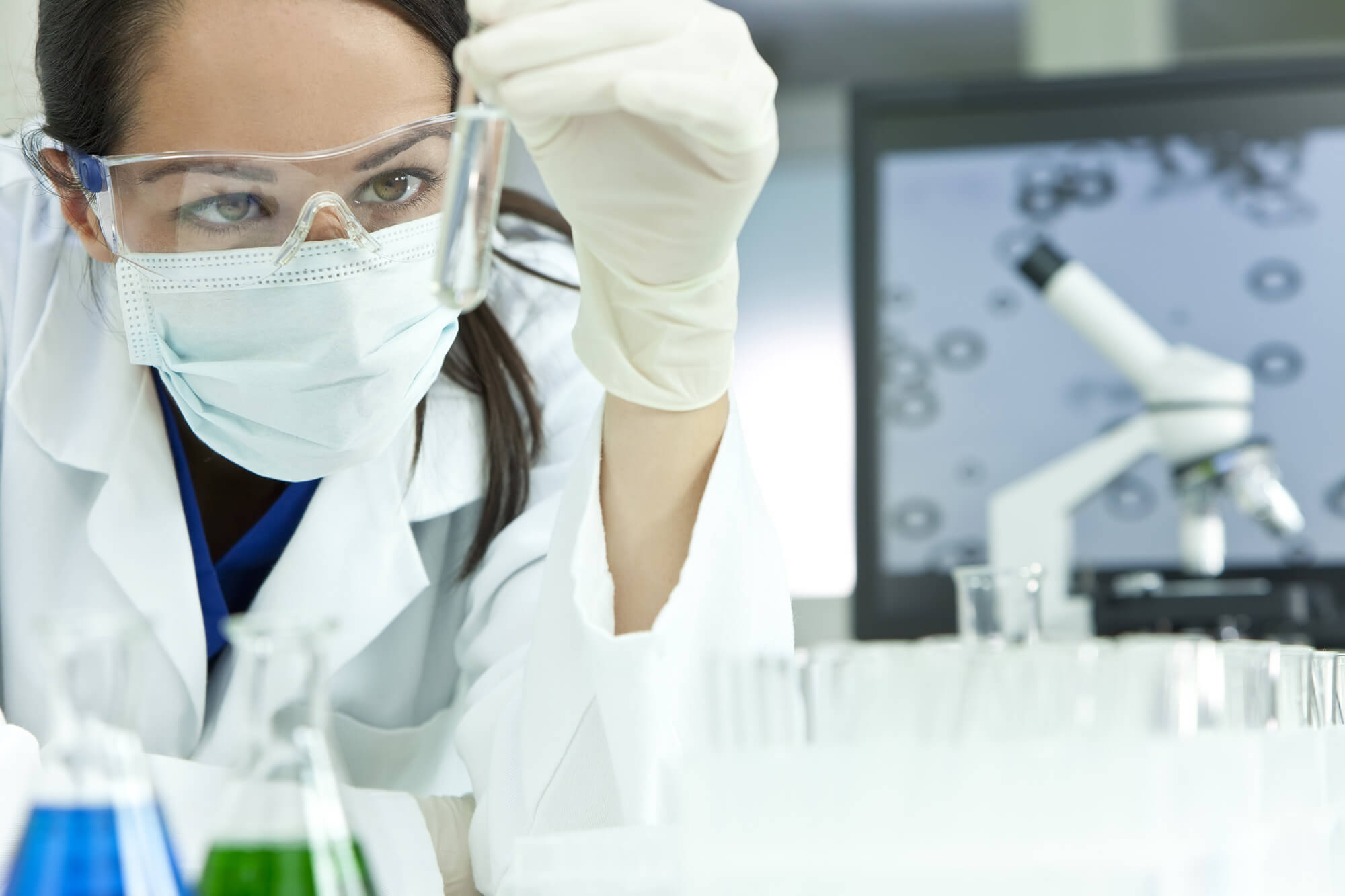 A scientist observing a prepared sample in a modern laboratory