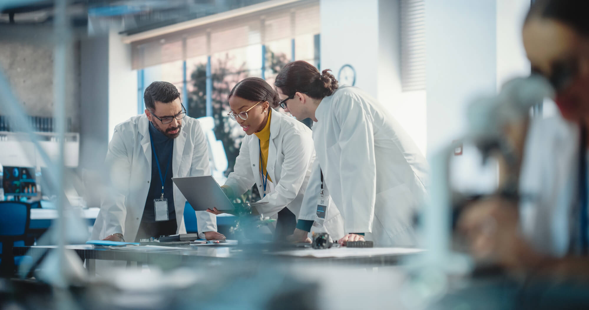 Research team in a private laboratory meeting reviewing analytical results for biobased products