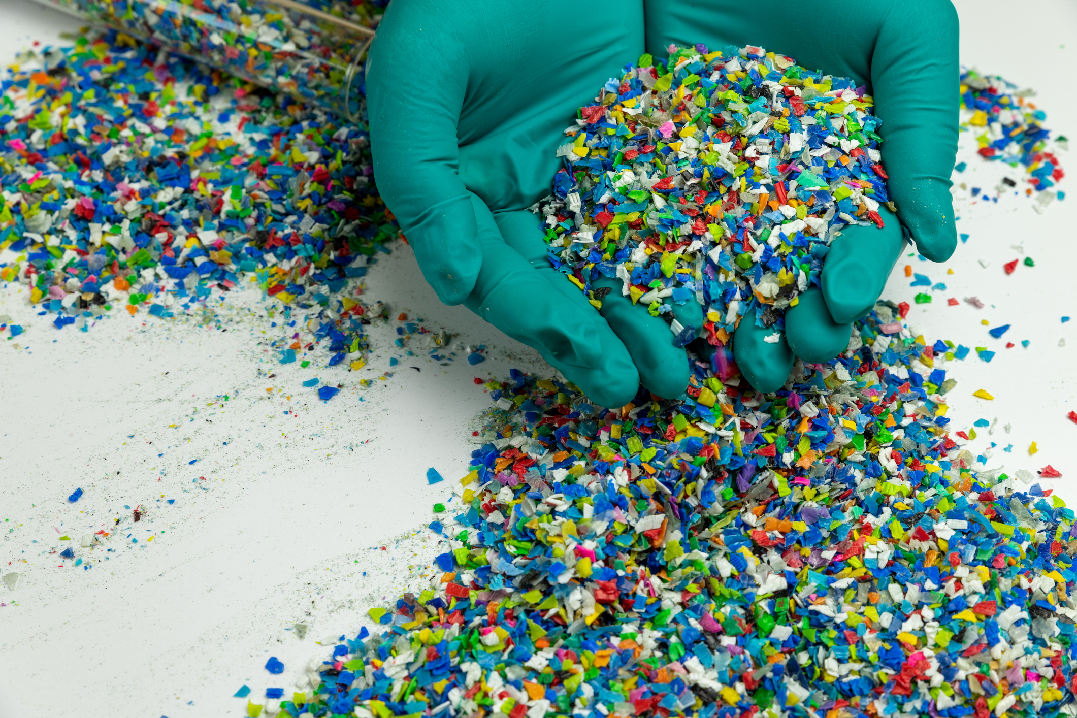 Plastic samples held in hand for determining biogenic carbon content
